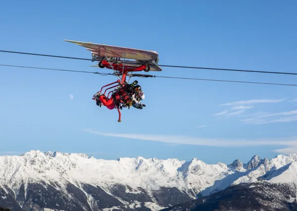 Gezin vliegt in een attractie over de piste