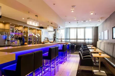 Sfeervolle bar en lounge met blauwe verlichting in Mercure Hotel Duisburg City