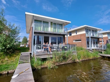 Vakantiehuisjes aan het water met steiger bij Landal Esonstad in Friesland