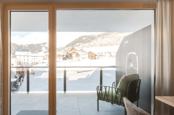Appartement met een balkon met uitzicht op het besneeuwde landschap